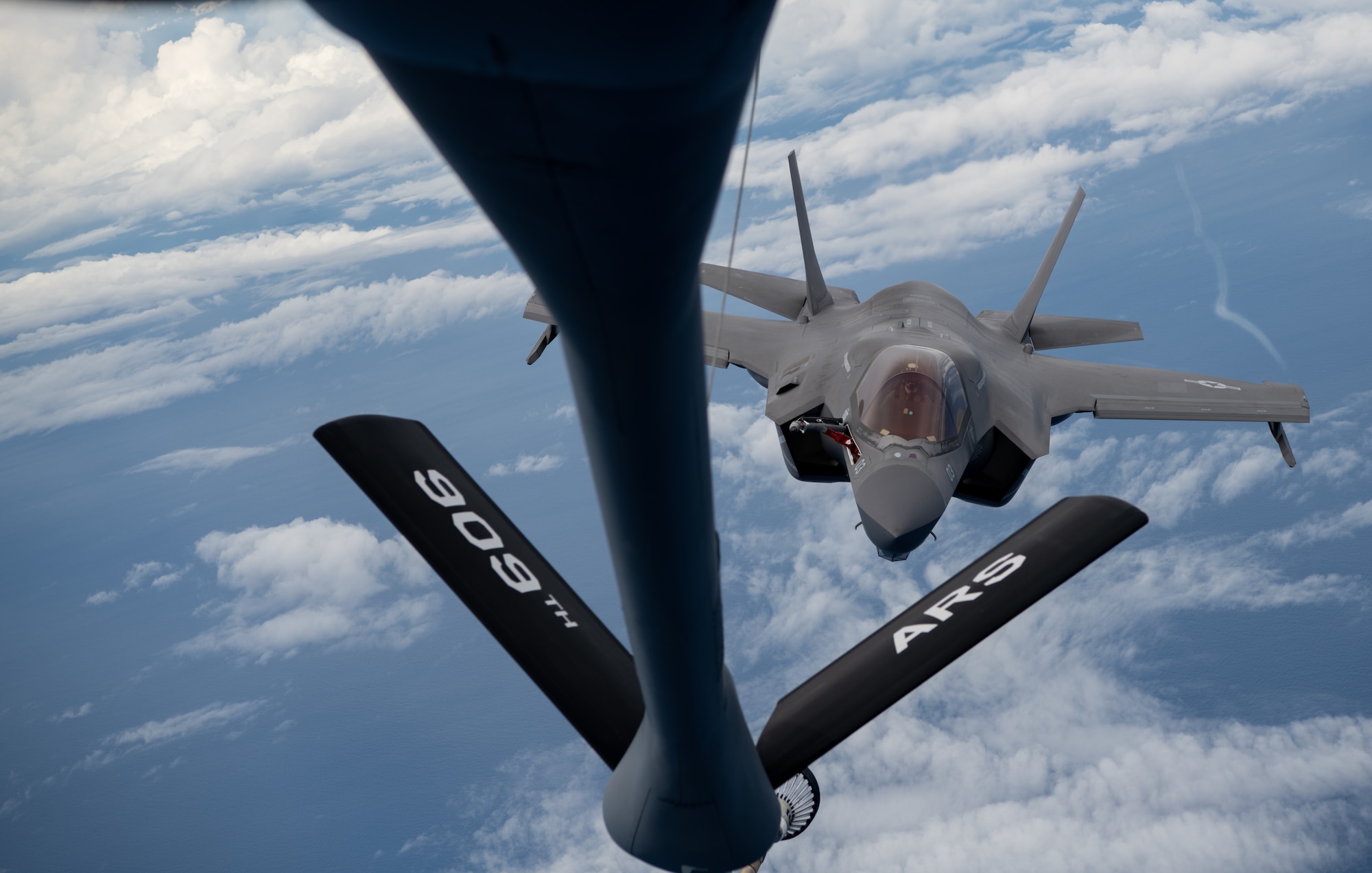 A U.S. Marine Corps F-35B Lightning II, Marine Fighter Attack Squadron based out of Marine Corps Air Station MCAS Iwakuni, Japan,  flies into position to receive fuel from a KC-135 Stratotanker assigned to the 909th Air Refueling Squadron, Kadena Air Base, Japan during a Large Scale Global Exercise 21 mission over the western Pacific Ocean, Aug. 18, 2021. U.S. joint forces is the most lethal, capable, and innovative fighting force operating today. (U.S. Air Force photo by Tech. Sgt. Micaiah Anthony)