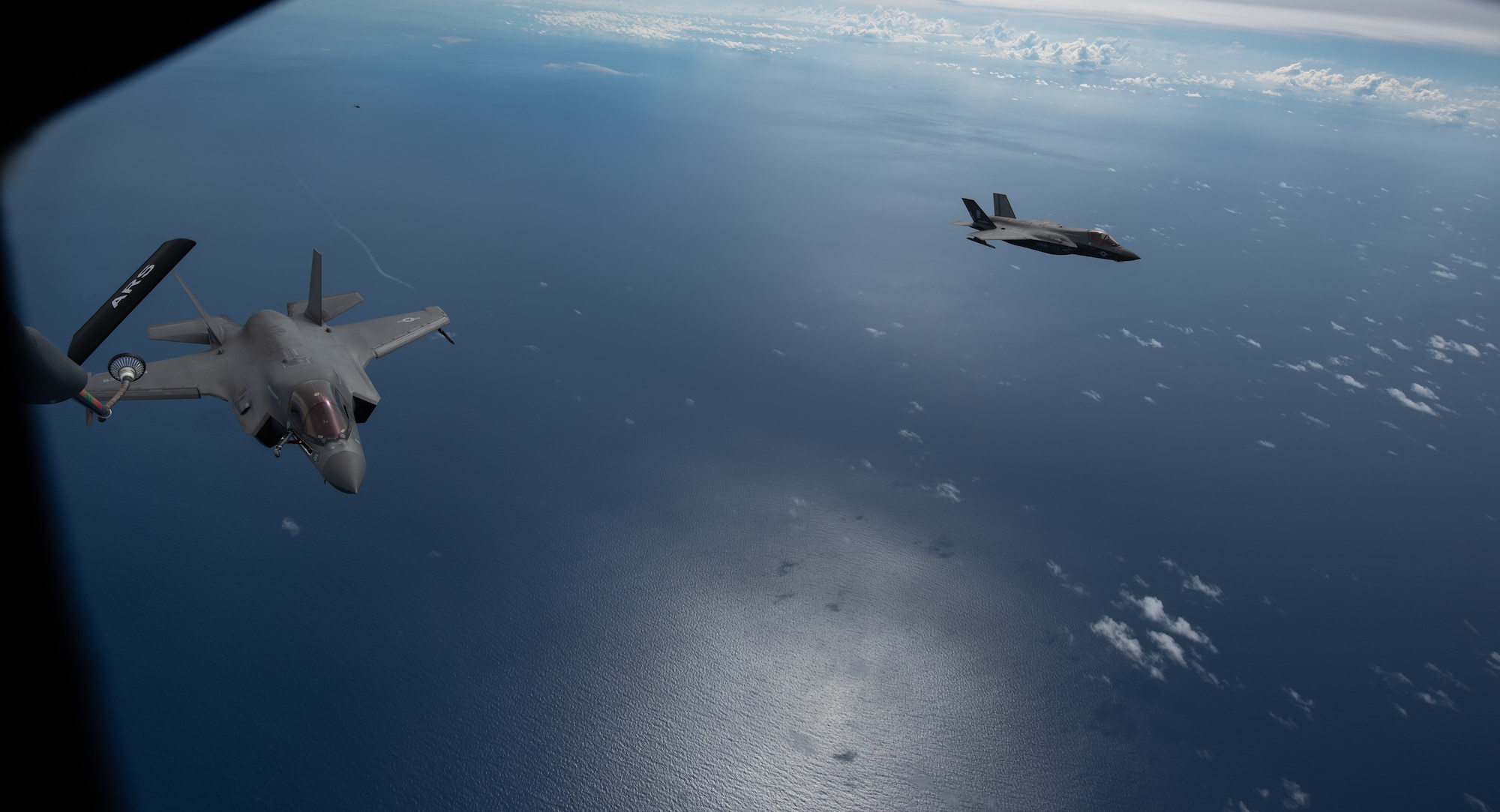 U.S. Marine Corps F-35B Lightning II’s,  Marine Fighter Attack Squadron based out of Marine Corps Air Station MCAS Iwakuni, Japan, prepare to receive fuel from a KC-135 Stratotanker assigned to the 909th Air Refueling Squadron, Kadena Air Base, Japan during a Large Scale Global Exercise 21 mission over the western Pacific Ocean, Aug. 18, 2021. The U.S. has the ability to operate from the sanctuary of bases across the region and projecting sustained combat power. (U.S. Air Force photo by Tech. Sgt. Micaiah Anthony)