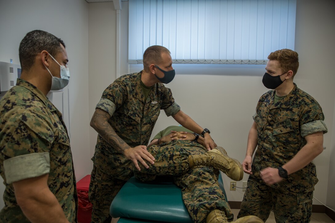 U.S. Navy Hospital Corpsman 1st Class, Peter Daniel, middle, an independent duty corpsman with 3d Marine Logistics Group, teaches basic provider skills to corpsmen during a Corpsman Critical Exchange Program on Camp Hansen, Okinawa, Japan, Aug 6, 2021. The purpose of the CCEP is to enhance basic corpsman abilities in order to perform provider related tasks. 3d MLG, based out of Okinawa, Japan, is a forward deployed combat unit that serves as III Marine Expeditionary Force’s comprehensive logistics and combat service support backbone for operations throughout the Indo-Pacific area of responsibility. (U.S. Marine Corps photo by Lance Cpl. Courtney A. Robertson)