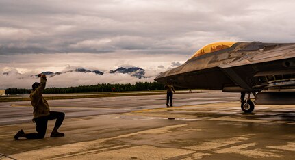 An Airman preps an F-22.