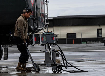 An Airman preps an F-22.