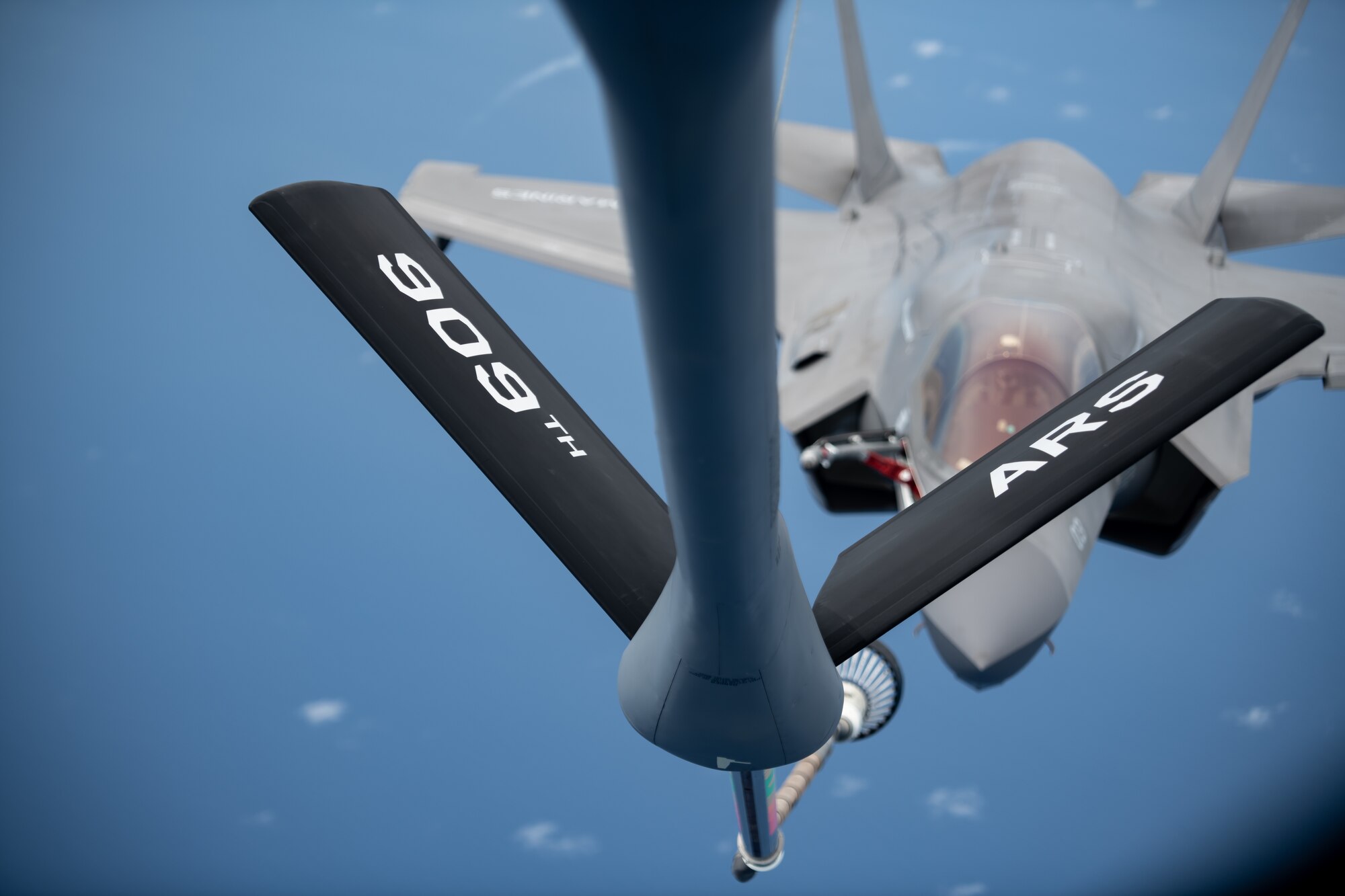 A U.S. Marine Corps F-35B Lightning II, Marine Fighter Attack Squadron based out of Marine Corps Air Station MCAS Iwakuni, Japan, flies into position to receive fuel from a KC-135 Stratotanker assigned to the 909th Air Refueling Squadron, Kadena Air Base, Japan during a Large Scale Global Exercise 21 mission over the western Pacific Ocean, Aug. 18, 2021. The U.S. has the ability to operate from the sanctuary of bases across the region and projecting sustained combat power.  (U.S. Air Force photo by Tech. Sgt. Micaiah Anthony)