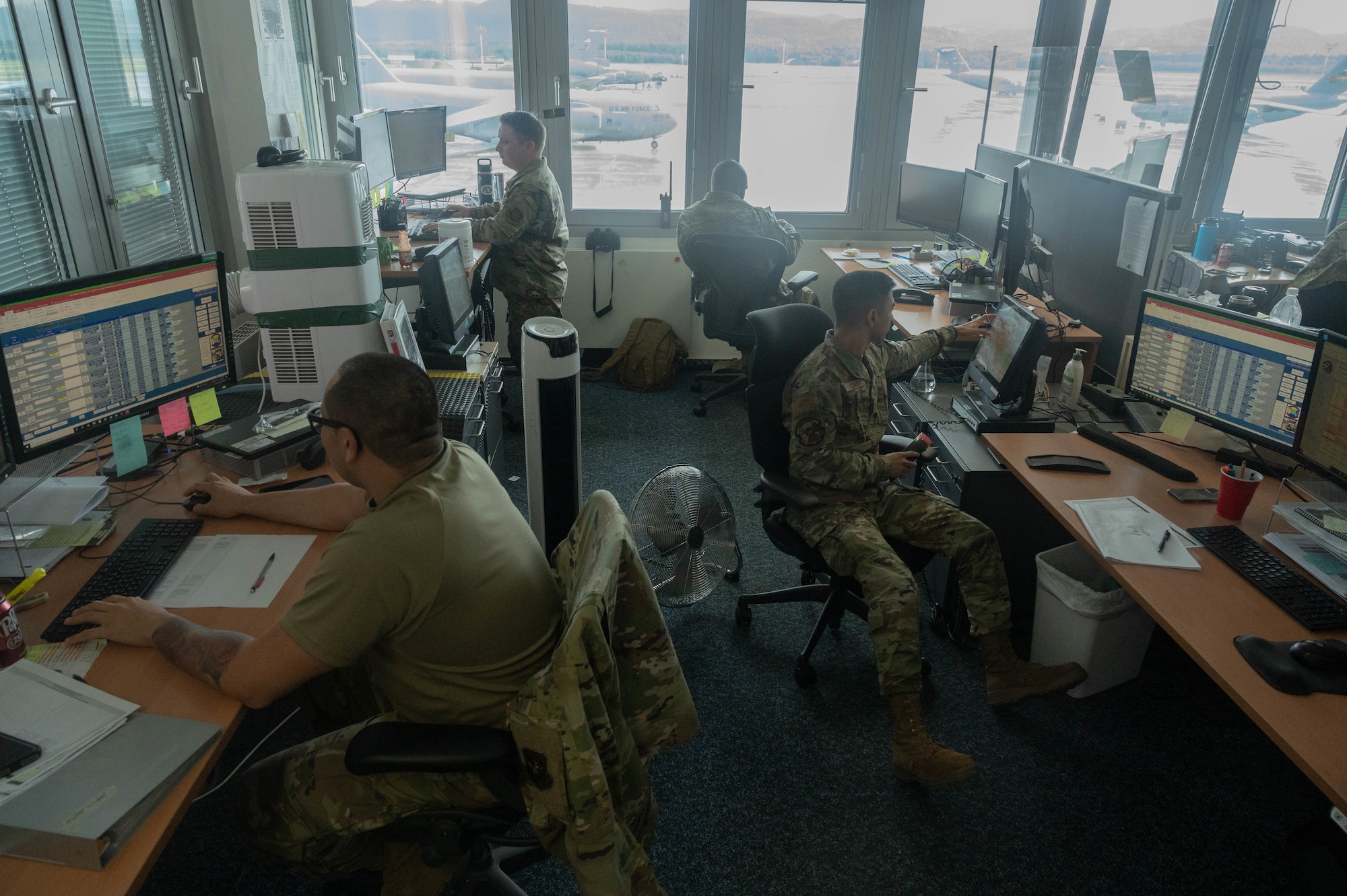 Airmen work in office.