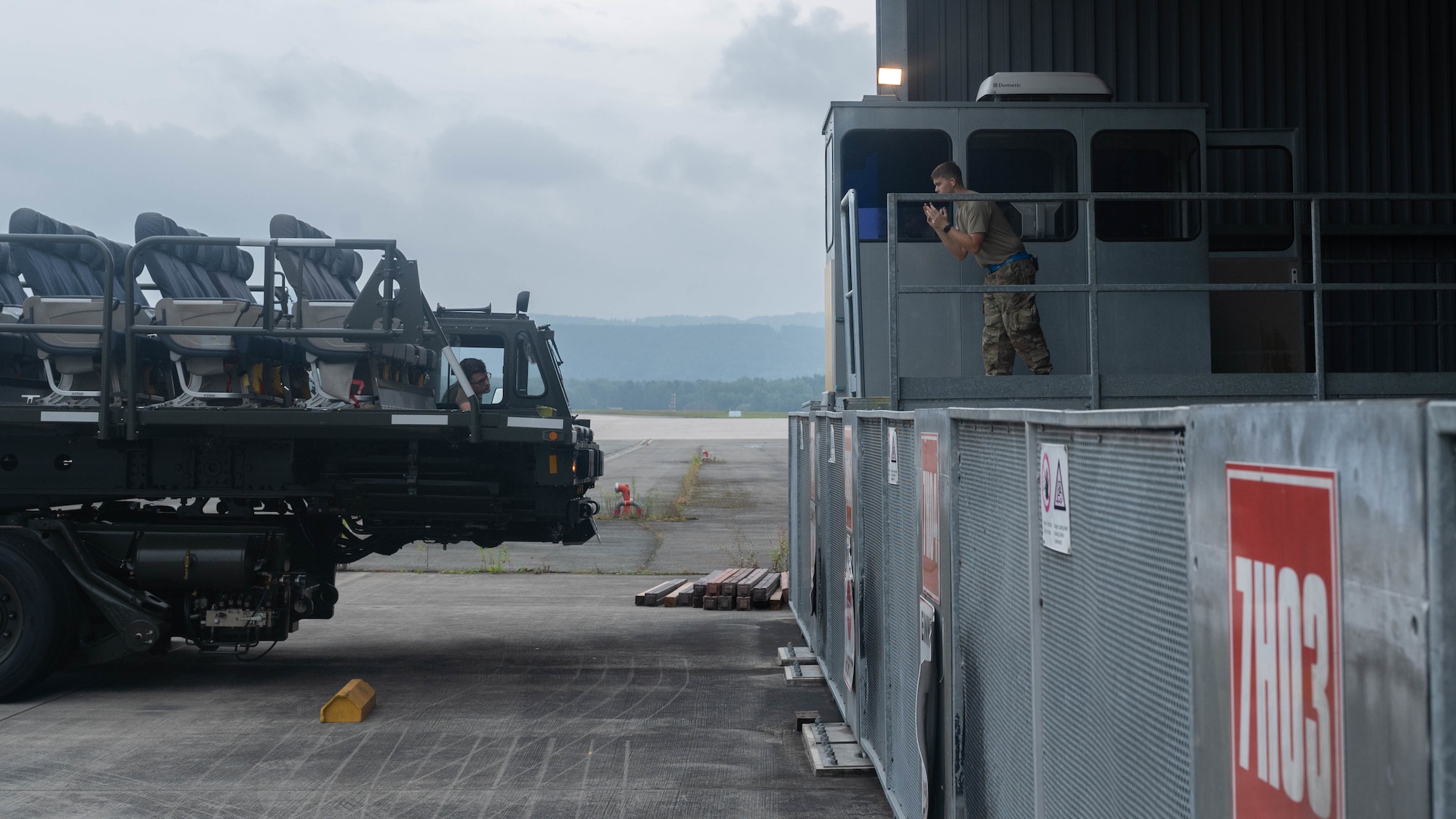 Airman directs cargo vehicle.