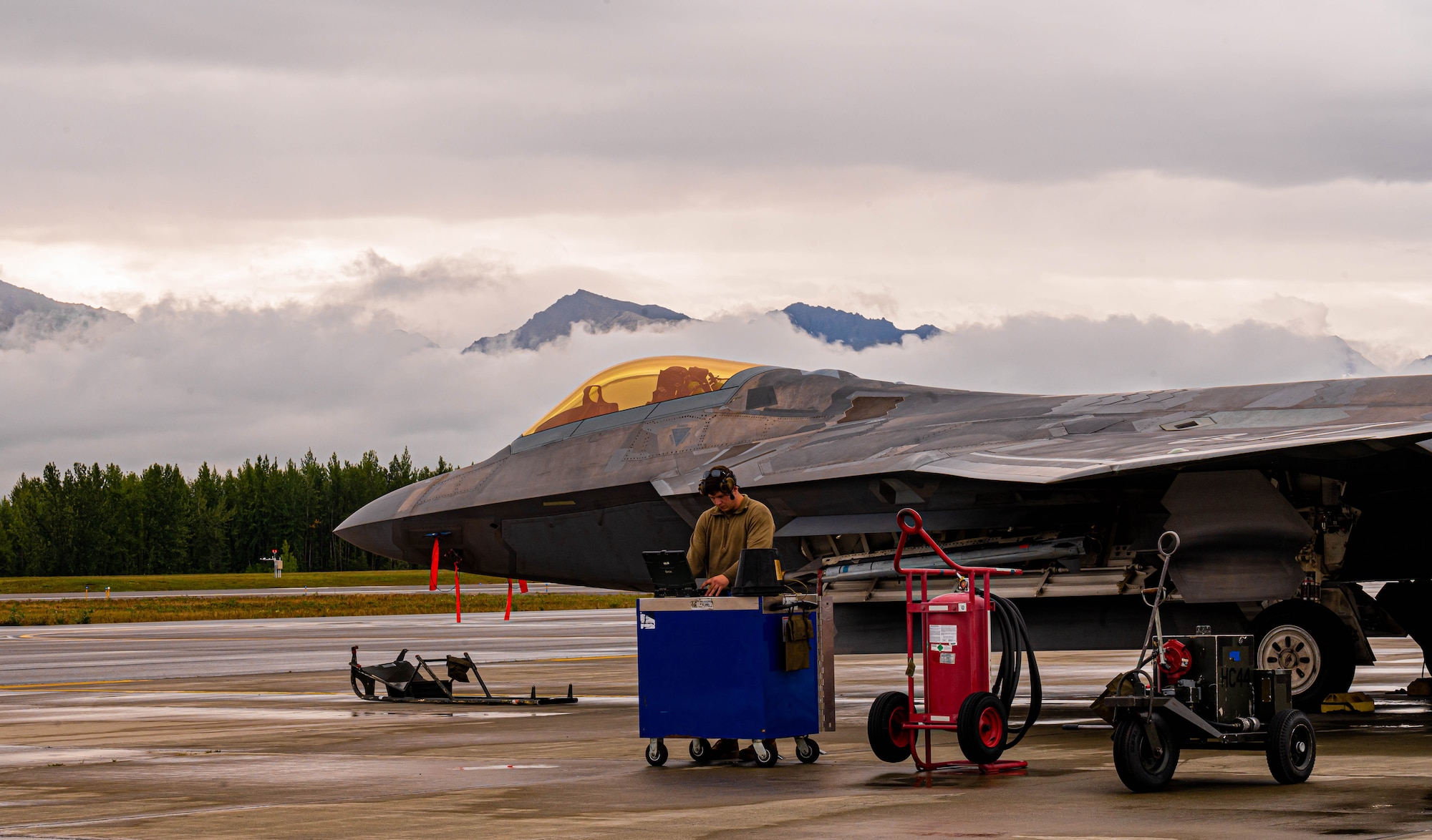 An Airman preps an F-22.