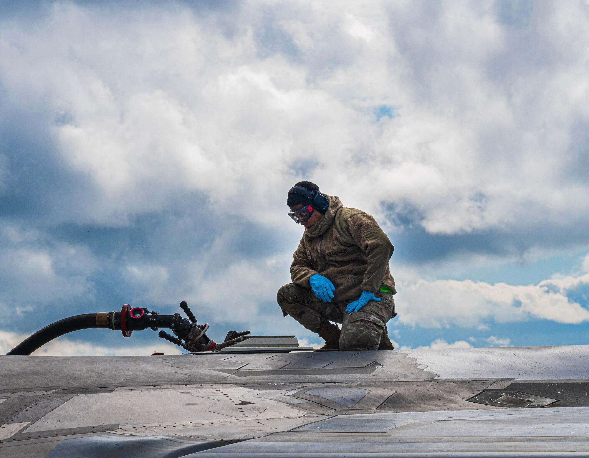 An Airman preps an F-22.