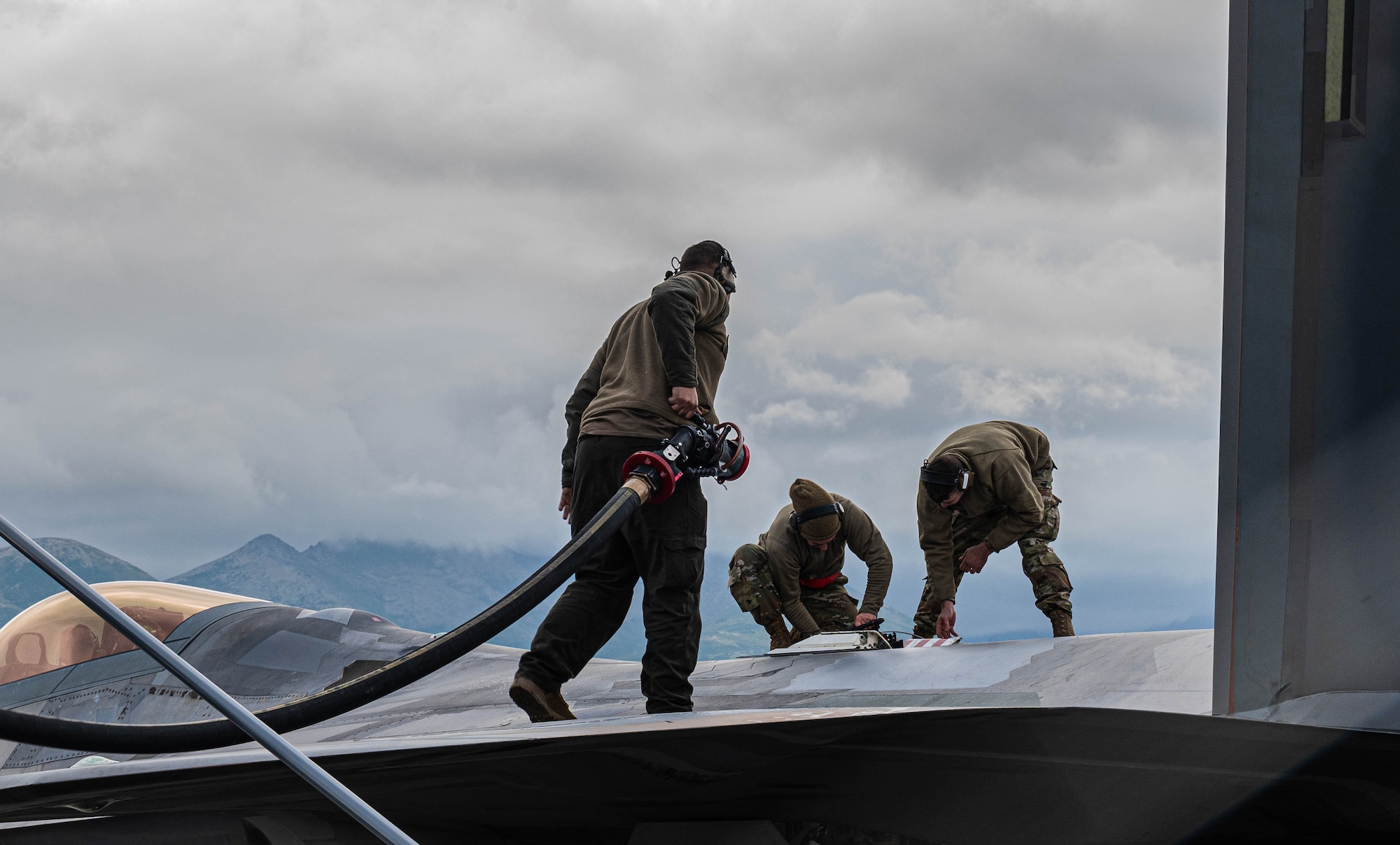 An Airman preps an F-22.