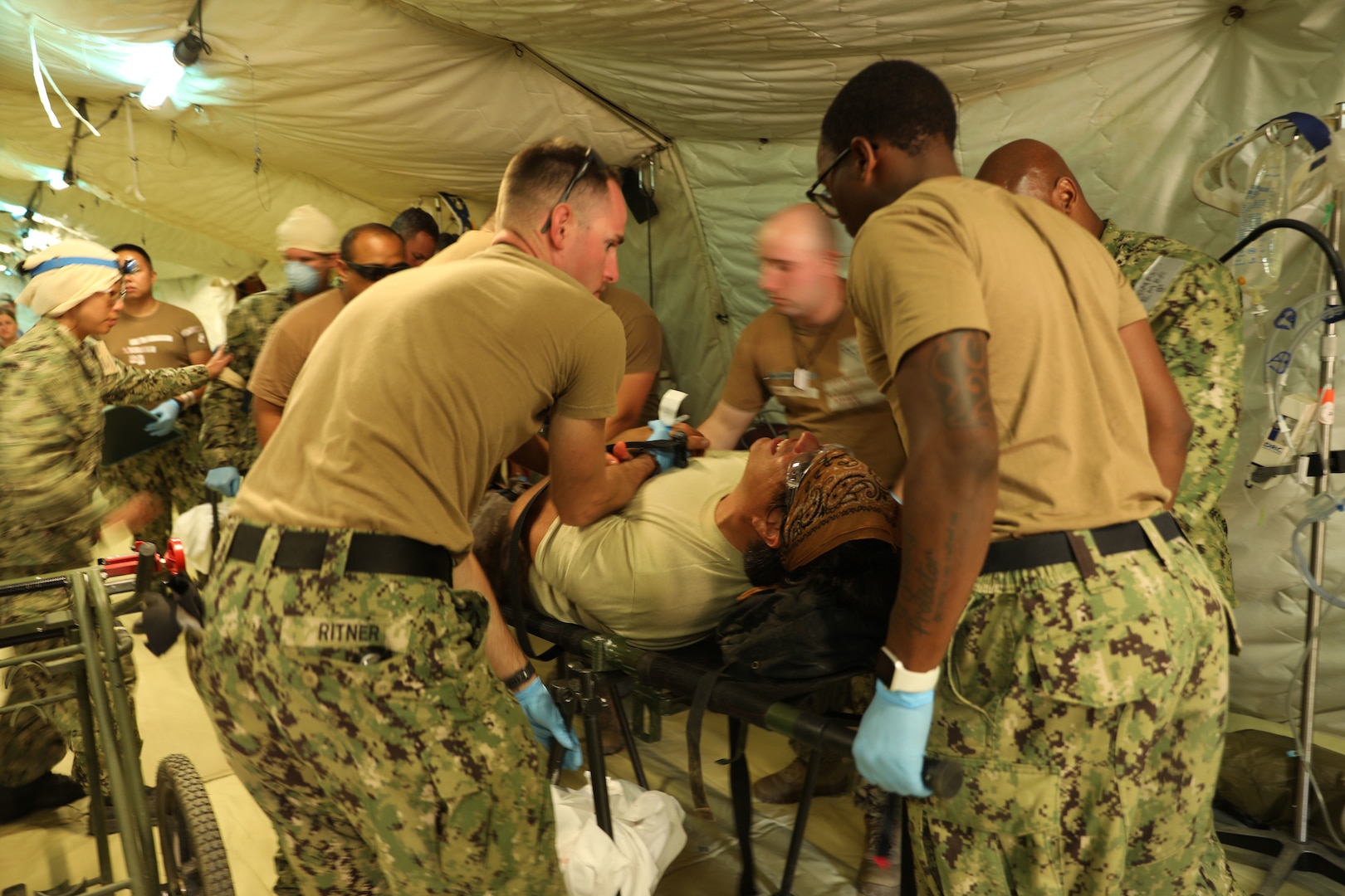 CAMP PENDLETON, Calif. (June 21, 2021) - Medical personnel assigned to Navy Expeditionary Medical Facility - M care for a simulated patient during a training exercise at Naval Expeditionary Medical Training Institute at Camp Pendleton, California.  The evolution evaluated the EMF’s patient processing and coordination across functional areas.  As a result, the EMF was certified with Tier 1 capability, with the ability to deploy and provide combat operations medical support to U.S. Fleet Forces.  (U.S. Navy photo by Hospital Corpsman 1st Class Nesinee Weber, Naval Expeditionary Medical Training Institute/ Released).