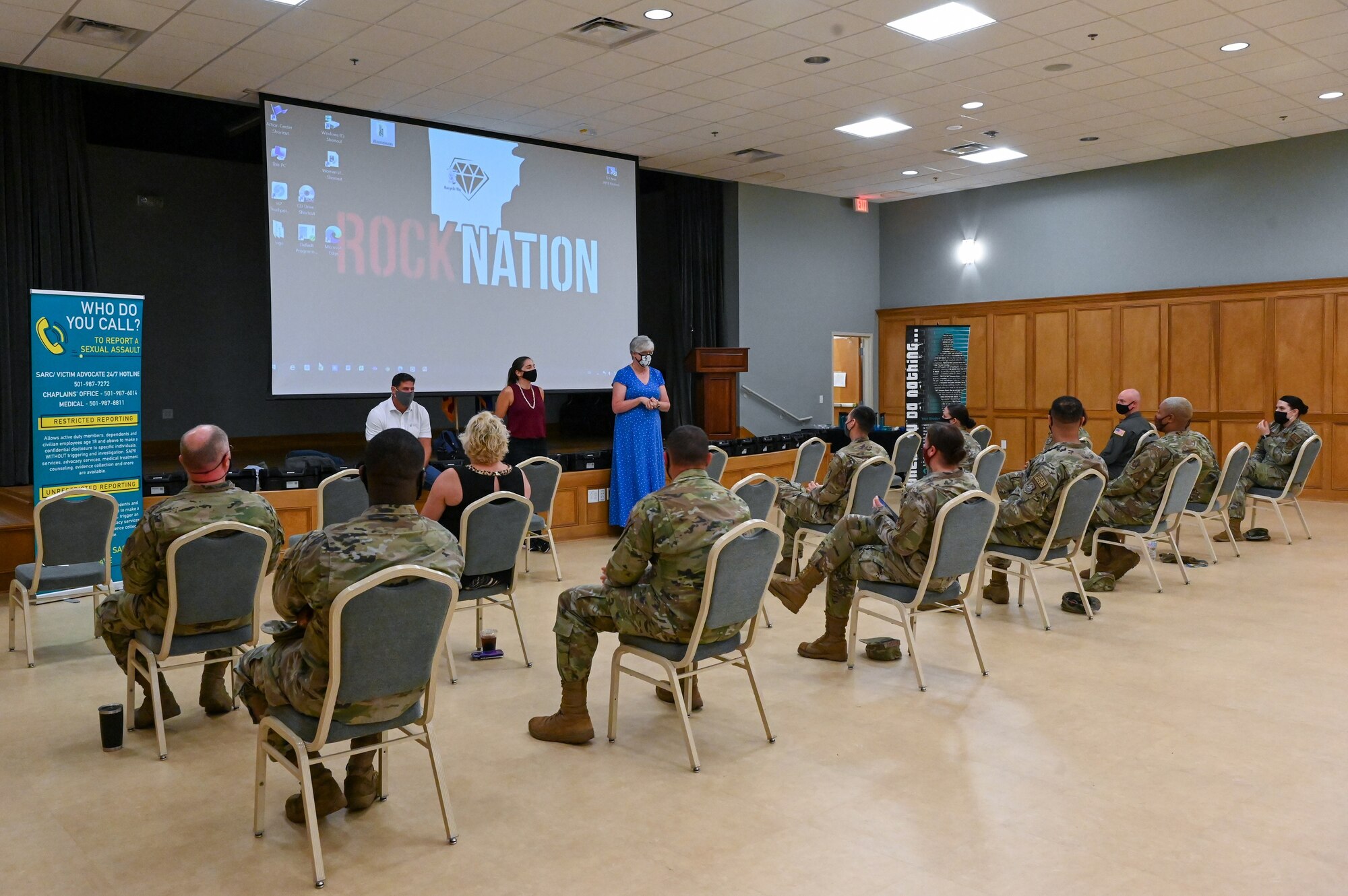 A group of people listen to a briefing