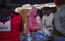 Evacuees receive donated goods.