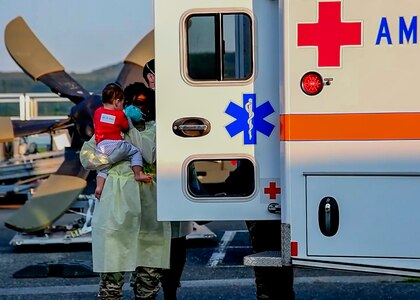 Airmen provides comfort to an evacuee child.