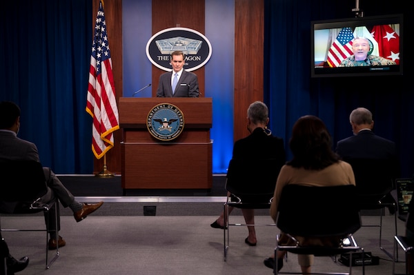 A man stands at a lectern.