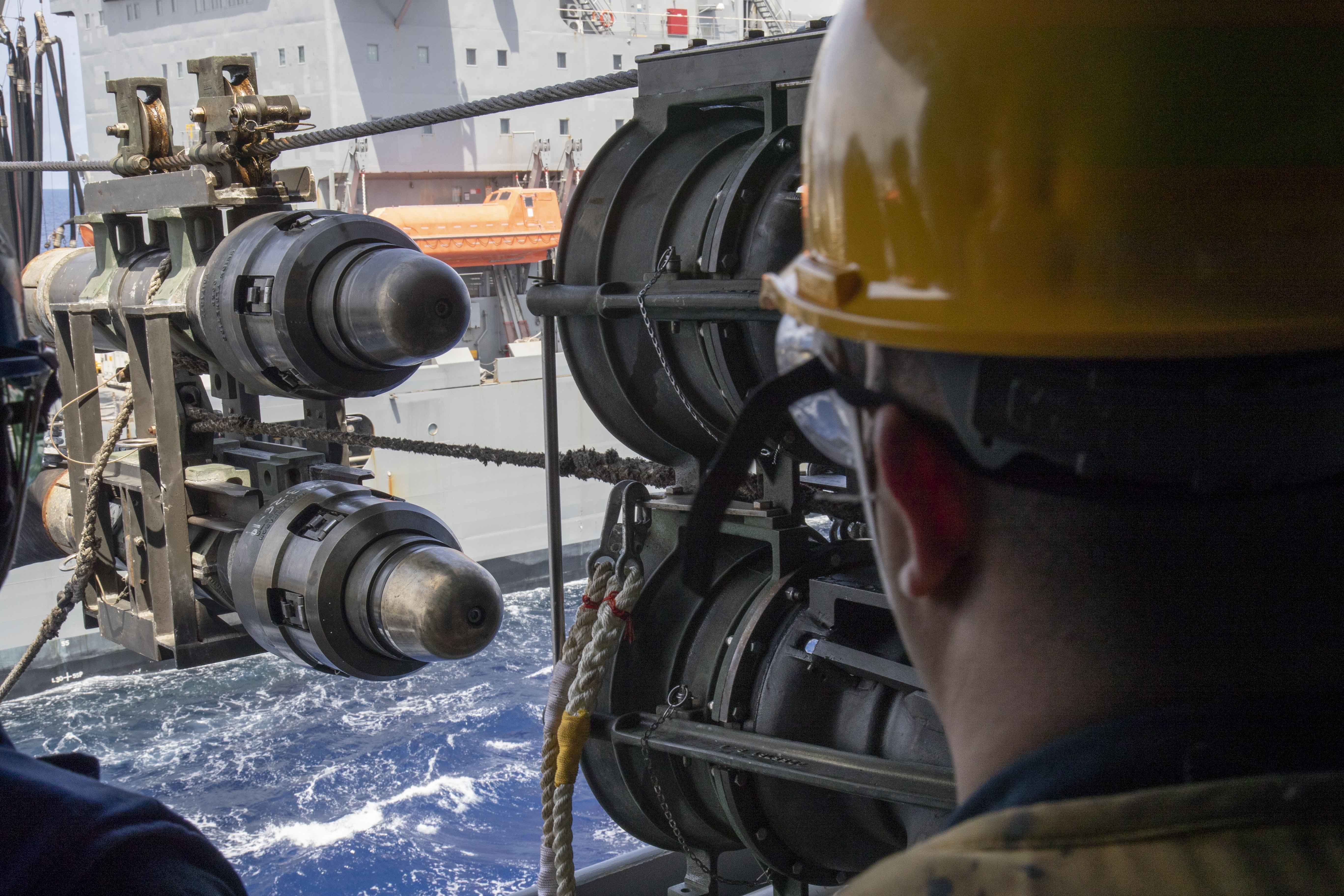 Boatswain's Mate 1st Class Sebastian Castano observes the fuel probe aboard the amphibious transport dock ship USS Green Bay (LPD 20) during a replenishment-at-sea with the Military Sealift Command Henry J. Kaiser-class underway replenishment oiler USNS Tippecanoe (T-AO 199).