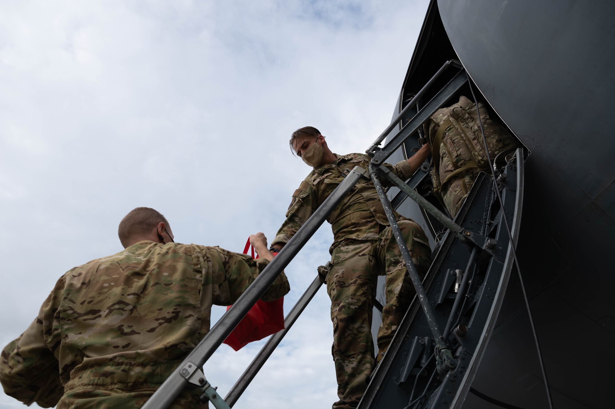 First Lt. Cole Wolf, right, and Maj. Zackery Williams, both 9th Airlift Squadron pilots, load bags onto a C-5M Super Galaxy before takeoff to Hamid Karzai International Airport, Afghanistan from Dover Air Force Base, Delaware, Aug. 16, 2021. Air Mobility Airmen play a key role in facilitating the safe departure and relocation of U.S. citizens, Special Immigration Visa recipients, and vulnerable Afghan populations from Afghanistan. (U.S. Air Force photo by Senior Airman Faith Schaefer)