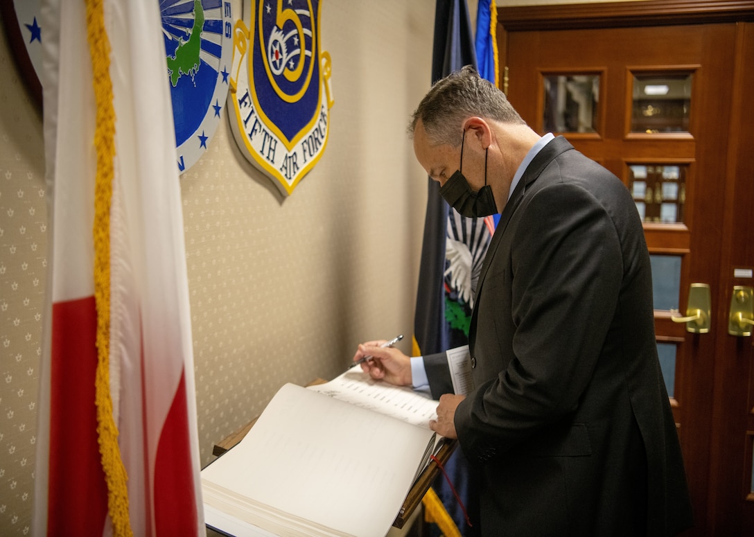 Second Gentleman of the United States, Douglas Emhoff signs the USFJ visitor’s book at the USFJ Headquarters building at Yokota Air Base, August 23, 2021. The guest book was introduced at the opening of USFJ headquarters for historical documentation and has been signed be every distinguished visitor ever since.  (U.S. Air Force photo by Staff Sergeant Braden Anderson)