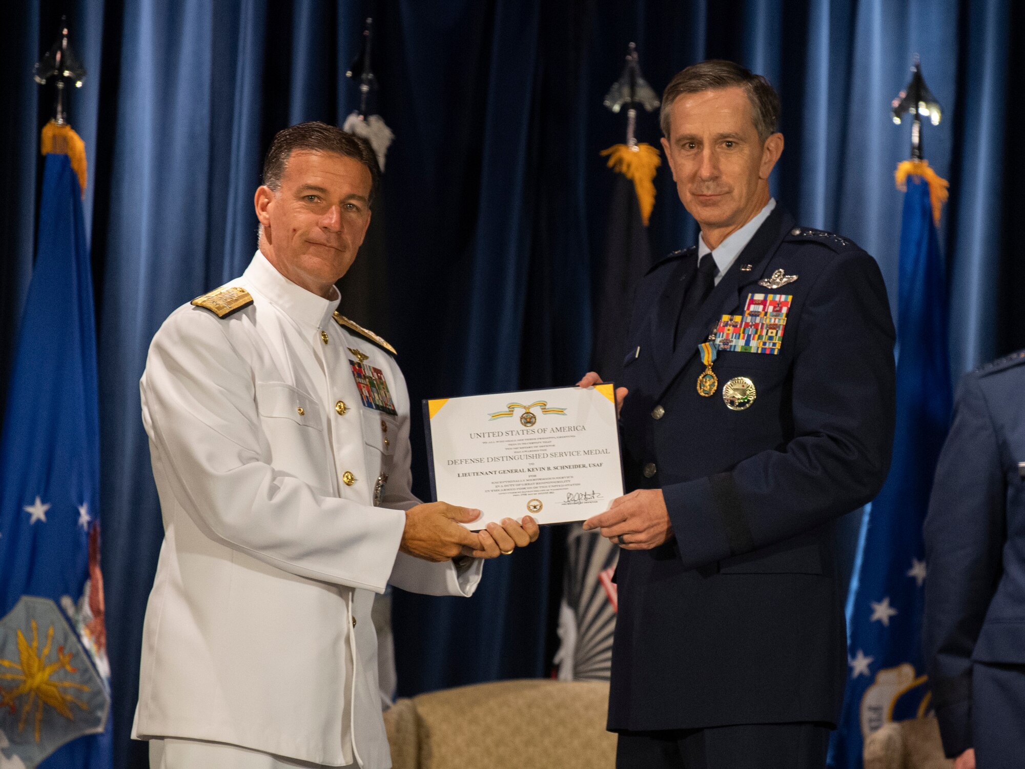Admiral John C. Aquilino, U.S. Indo-Pacific Command commander, presents the Defense Distinguished Service award to Lt. Gen. Kevin B. Schneider, U.S. Forces Japan and 5th Air Force outgoing commander, during the USFJ and 5th AF change of command ceremony at Yokota Air Base, Japan, Aug. 27, 2021.