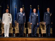 The official party stands at attention during the U.S. Forces Japan and 5th Air Force change of command ceremony at Yokota Air Base, Japan, Aug. 27, 2021. During the ceremony, Lt Gen. Ricky N. Rupp assumed command of USFJ and 5th AF from Lt. Gen. Lt. Gen. Kevin B. Schneider. (U.S. Air Force photo by Senior Airman Brieana E. Bolfing)