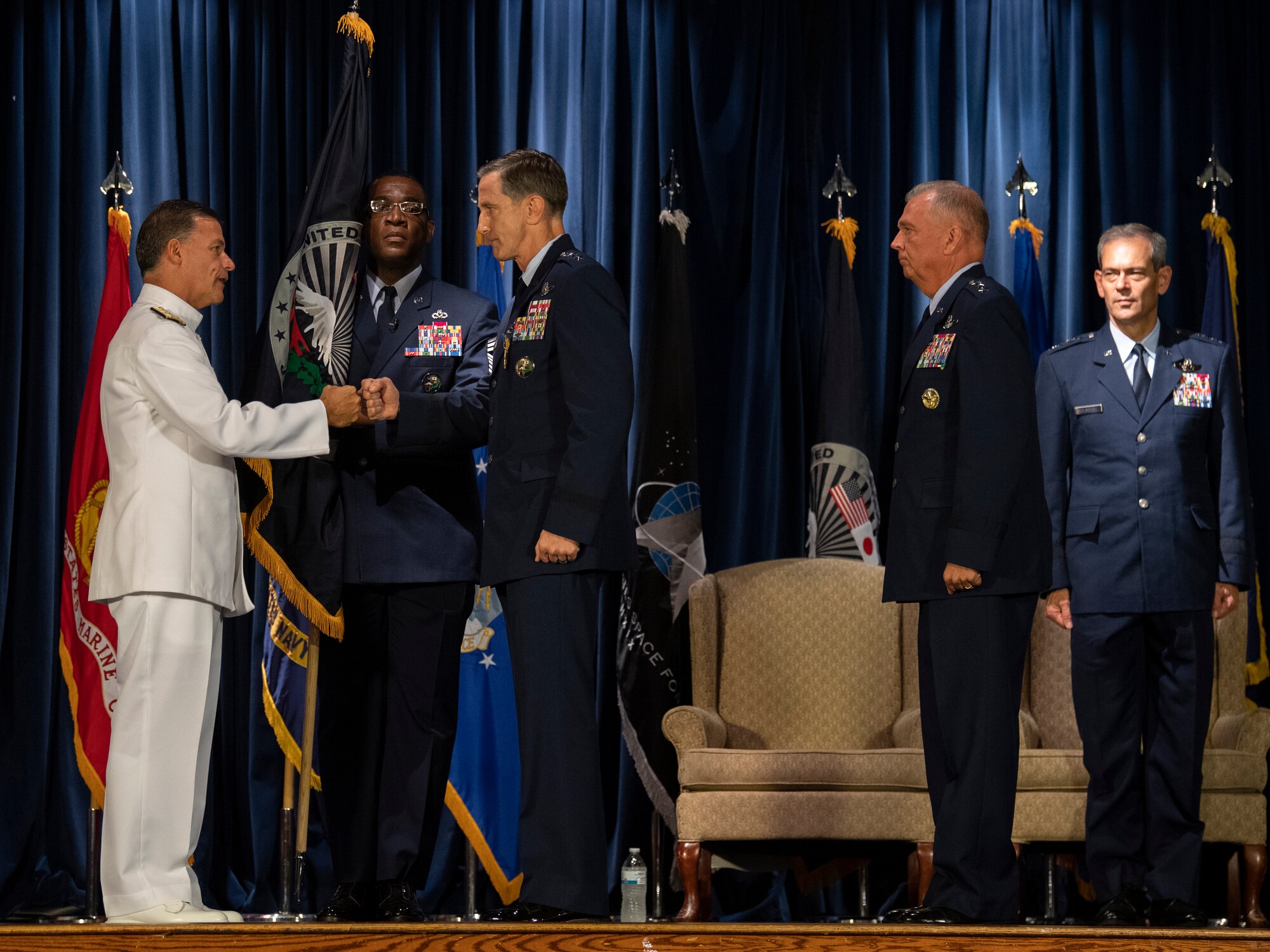 Admiral John C. Aquilino, left, U.S. Indo-Pacific Command commander, thanks Lt. Gen. Kevin B. Schneider, center, U.S. Forces Japan and 5th Air Force outgoing commander, for his service during the USFJ and 5th AF change of command ceremony at Yokota Air Base, Japan, Aug. 27, 2021.