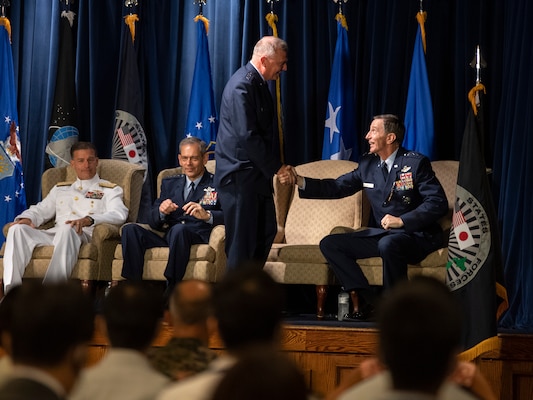 Lt. Gen. Kevin B. Schneider, former U.S. Forces Japan and 5th Air Force commander, congratulates Lt. Gen. Ricky N. Rupp, USFJ and 5th AF commander, during the USFJ and 5th AF change of command ceremony at Yokota Air Base, Japan, Aug. 27, 2021. During the ceremony, Rupp assumed command of USFJ and 5th AF from Schneider. (U.S. Air Force photo by Senior Airman Brieana E. Bolfing)