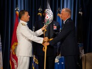 U.S. Admiral John C. Aquilino, U.S. Indo-Pacific Command commander, passes the U.S. Forces Japan guidon to Lt. Gen. Ricky N. Rupp, USFJ and 5th Air Force incoming commander, during a change of command ceremony at Yokota Air Base, Japan, Aug. 27, 2021. The passing of the guidon marks the beginning of Rupp’s tour as the commander of USFJ. (U.S. Air Force photo by Senior Airman Brieana E. Bolfing)