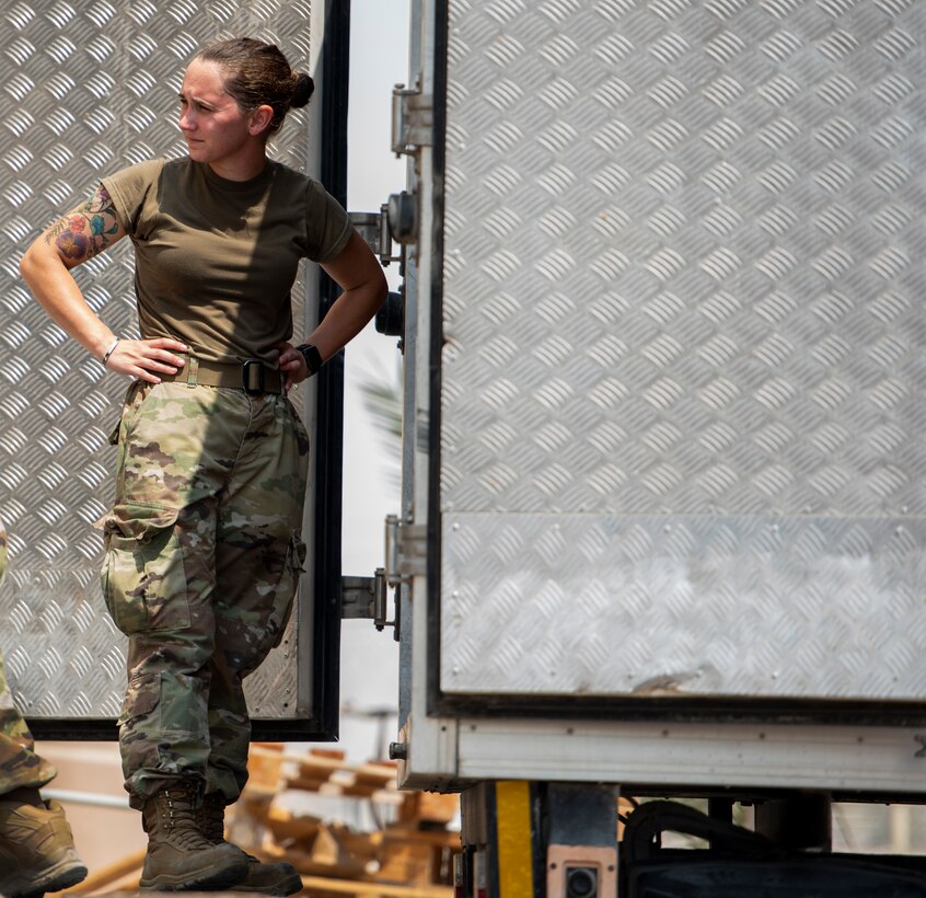 Staff Sgt. Emily Candel, 379th Expeditionary Force Support Squadron dining facility board member, waits to unload food for qualified evacuees Aug. 25, 2021, at Al Udeid Air Base, Qatar.
