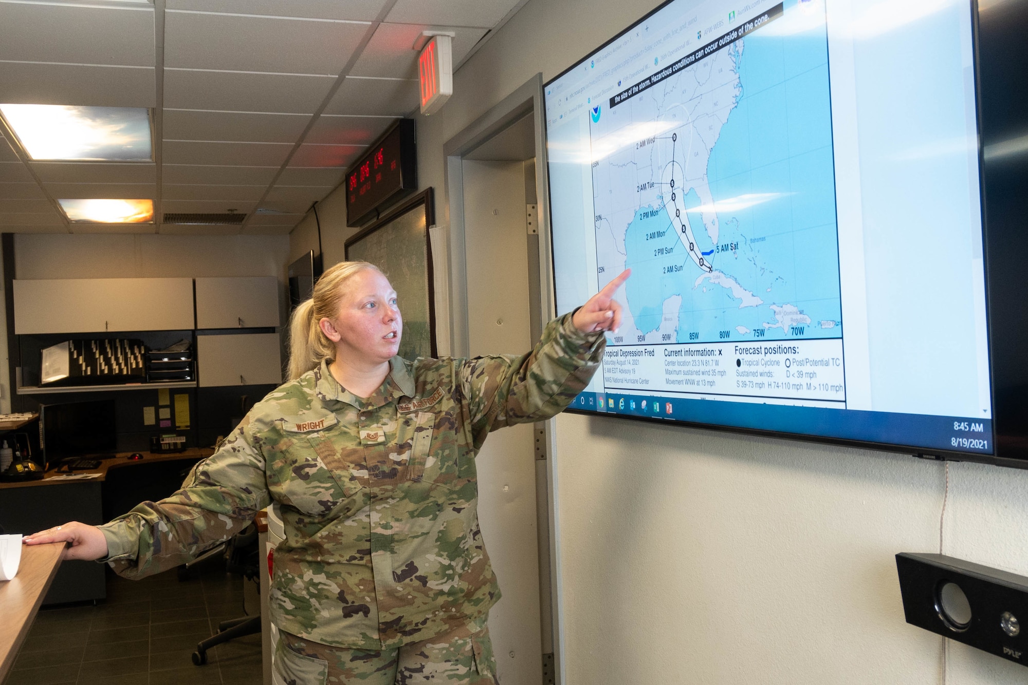 U.S. Air Force Tech. Sgt. Mandy Wright, a 23rd Special Operations Weather Squadron weather craftsman, explains what the trajectory was for Tropical Depression Fred Aug. 19, 2021 at Hurlburt Field, Florida. Weather technicians monitor national hurricane data and relay the information to the wing commander and mission partners. (U.S. Air Force photo by Staff Sgt. Rito Smith)