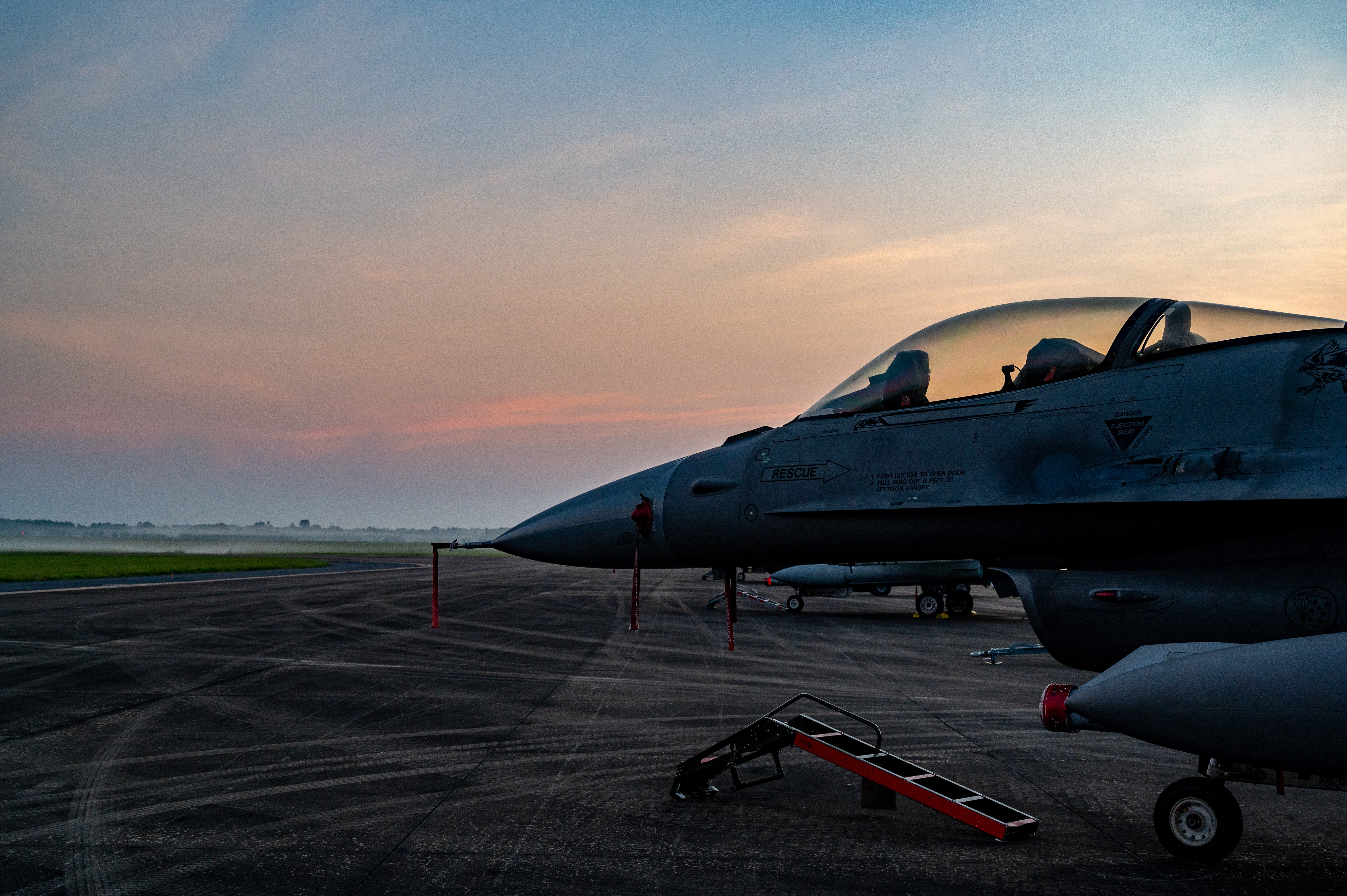 A picture of a jet on the flightline.
