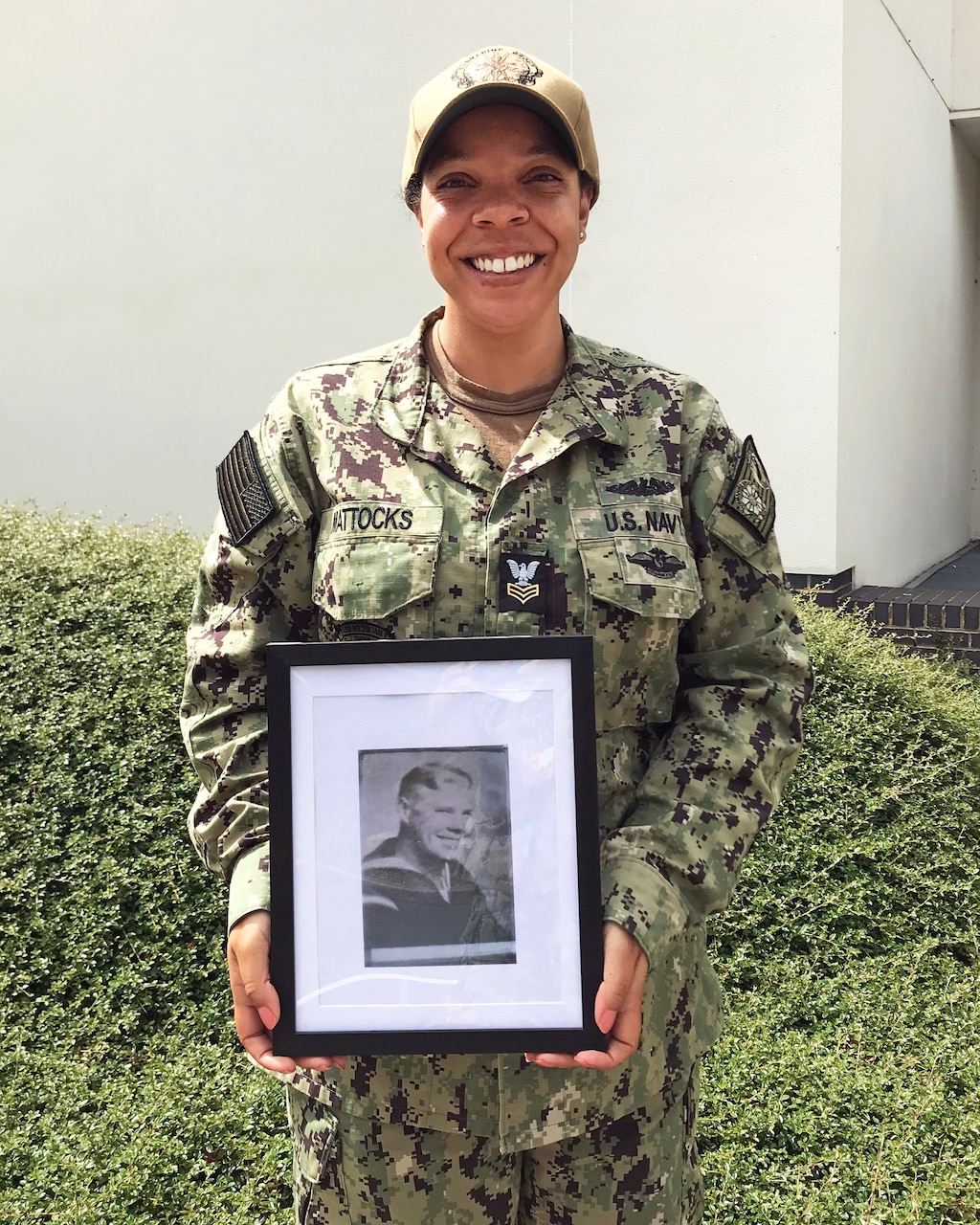 Yeoman 1st Class (Submarine) Suraya Mattocks holds a picture of her grandfather, Everett S. Jordan, at Submarine Group EIGHT Representative Northwood, UK. Aug. 5, 2021. Mattocks was one of the first 36 enlisted Female Sailors to volunteer for submarine in 2015, and was recently selected for the 21021 Master Chief Anna Der-Vartanian Leadership Award.