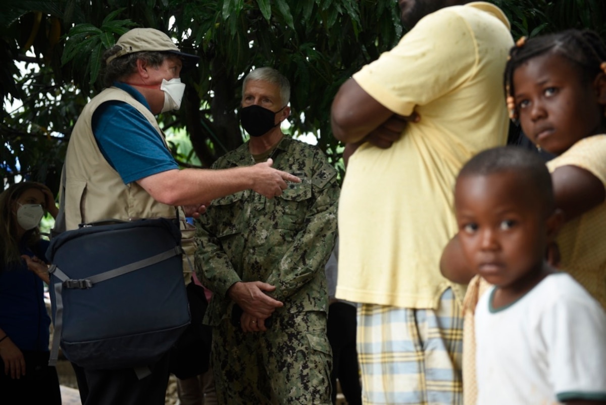 U.S. Navy Adm. Craig Faller, commander of U.S. Southern Command, and Tim Callahan, the senior regional advisor for Latin America and the Caribbean with U.S. Agency for International Development, discuss community needs and damages in Maniche, Haiti, Aug. 26, 2021.