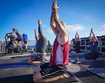 Coast Guard Cutter Steadfast (WMSL 623) crewmembers gather together for a team Yoga session during a rest day while patrolling in the Eastern Pacific Ocean. Balancing a high-operational tempo while patrolling in the Eastern Pacific Ocean, Coast Guard Cutter Steadfast prioritizes mental and physical health. The crew takes every advantage to foster a healthy lifestyle while underway as well as build comradery when possible. U.S. Coast Guard photo by Fireman Ryan Carroll.