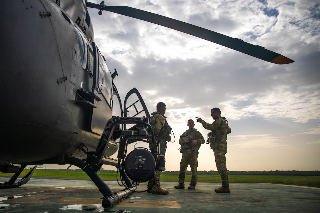 Sgt. Francisco Silva, Chief Warrant Officer two (CW2) Jean Rodriguez, and Chief Warrant Officer three (CW3) Norberto Martinez from the Puerto Rico Army National Guard Aviation conduct a crew-mission brief before departing to Port-au-Prince, Aug. 25, 2021