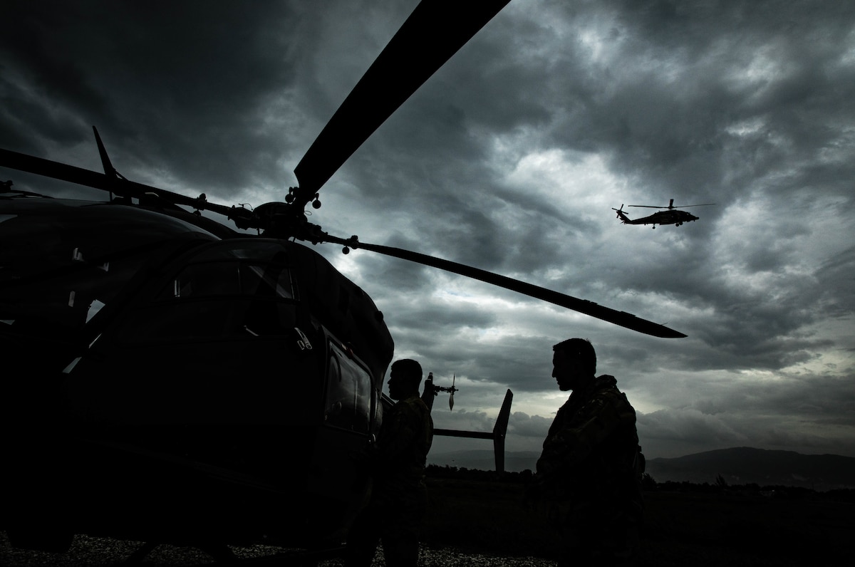 Sgt. Francisco Silva (left) and Chief Warrant Officer two (CW2) Jean Rodriguez (right) from the Puerto Rico Army National Guard Aviation disembark their UH-72 helicopter after returning from a reconnaissance mission over La Hatte, Haiti, Aug. 25, 2021.