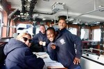 The bridge crew takes a moment for a photo on the Coast Guard Cutter Richard Snyder  in the Davis Strait on Aug. 9, 2021. Snyder worked alongside the Coast Guard Cutter Escanaba, the Royal Canadian Navy's HMCS Harry Dewolf , and HMCS Goose Bay  in Operation Nanook to enhance collective abilities to respond to safety and security issues in the High North through air and maritime presence activities, maritime domain defense, and security exercises. Left to right: Petty Officers 2nd Class Gayle Buchanan, and Zachary Weber, Seaman Kenan Carter, Ensign JT Cox. (U.S. Coast Guard photo by Coast Guard Cutter Richard Snyder)