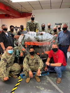 MARMC Diesel Shop personnel admire their new Detroit 12V71 diesel engine for training. Top row left to right:  Mr. George Tellefsen, EN2(SW) Jose Gonzalez, Mr. Erich Vanaman, EN1(SW) Rodney Ruth, EN1(SW/EXW) Pierre Warrenausby, ENCS(SW) Travis Steed, ENCS(SW/AW) Blake Morton, EN1(SW) Max Groneman, Mr. Ash Horn. Bottom row left to right: EN2(SW/AW) Anh Ta, EN2(SW) Kilafwa Aliksa, Mr. Andrew Porter, Regional NAMTS Coordinator.