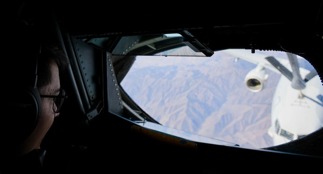 U.S. Air Force Airman 1st Class Christian Lawhorn, 92nd Air Refueling Squadron boom operator, performs air refueling to a Navy P-8 Poseidon from Naval Air Station Whidbey Island, Washington, during a teacher orientation flight while flying over Montana, Aug. 24, 2021. This teacher orientation flight was the first of its kind for the 92nd Air Refueling Wing, further showcasing the strong relationship between Team Fairchild and the local community.. (U.S. Air Force photo by Senior Airman Kiaundra Miller)