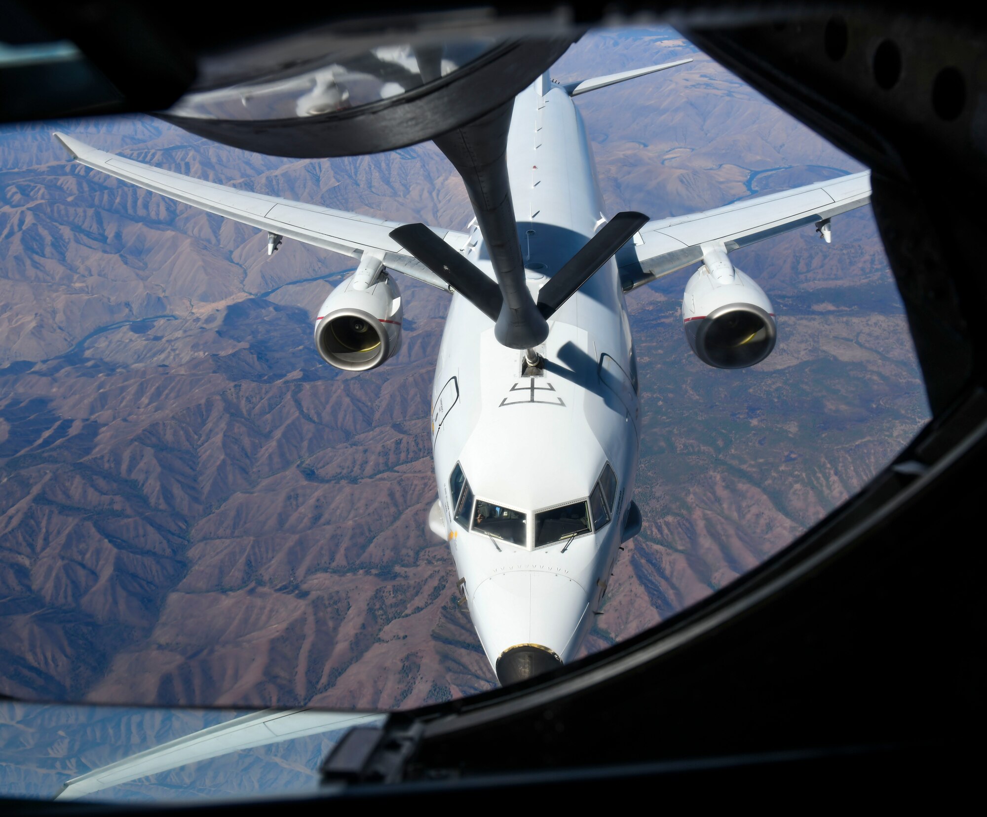 A KC-135 Stratotanker from Fairchild Air Force Base, Washington, refuels a Navy P-8 Poseidon from Naval Air Station Whidbey Island, during a teacher orientation flight while flying over Montana, Aug. 24, 2021. The teacher orientation flight showcased Fairchild’s mission to local educators to strengthen the partnership between local schools and the base. (U.S. Air Force photo by Senior Airman Kiaundra Miller)