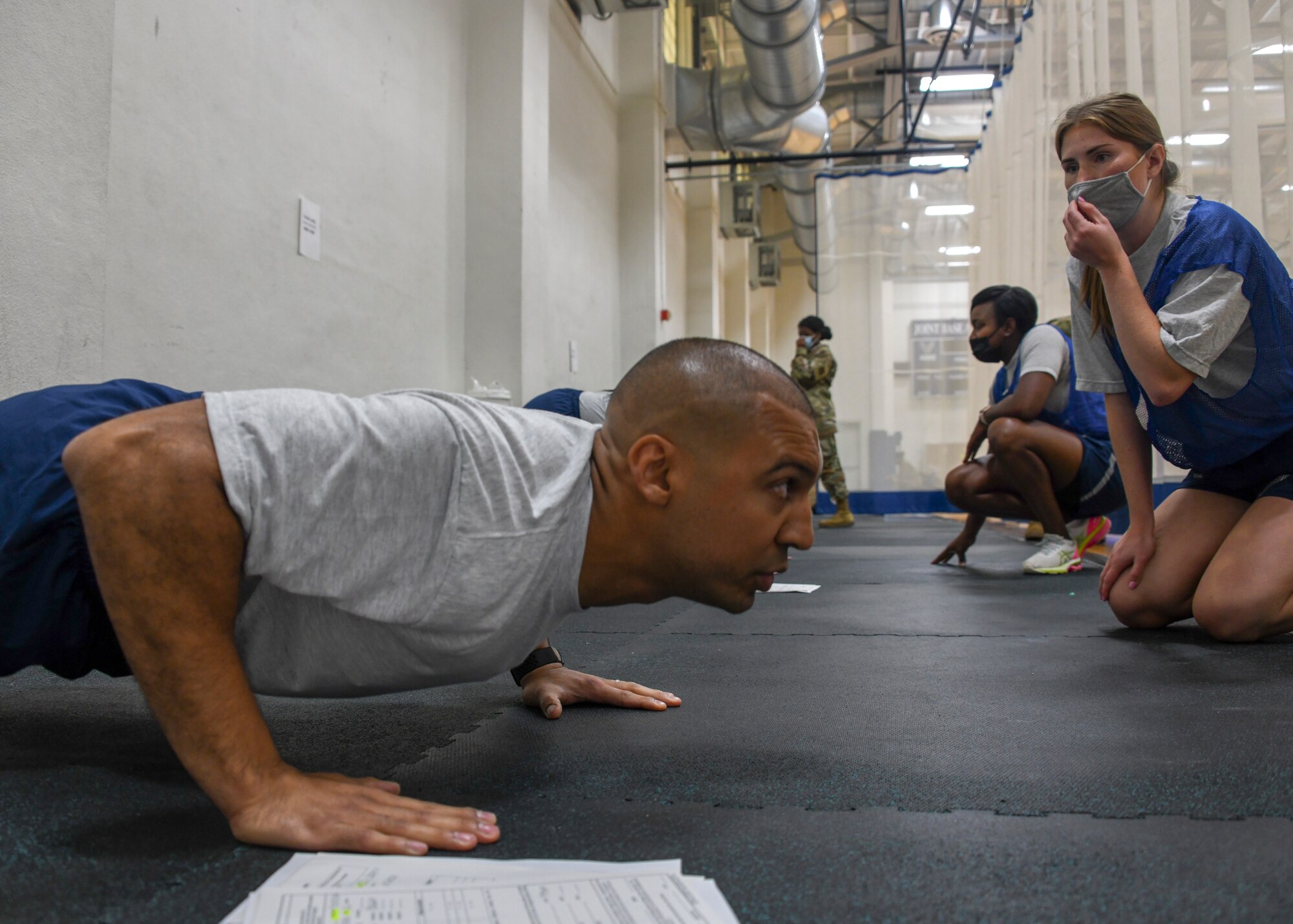 459th Air Refueling Wing Airmen count the push-ups of their partners August 14, 2021, at Joint Base Andrews, Md. The push-up portion of the test now weighs more towards the overall score being 20 points as opposed to 10 points. (U.S. Air Force photo by Senior Airman Andreaa Phillips)