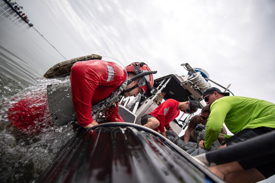 Photo of Airman climbing into a boat