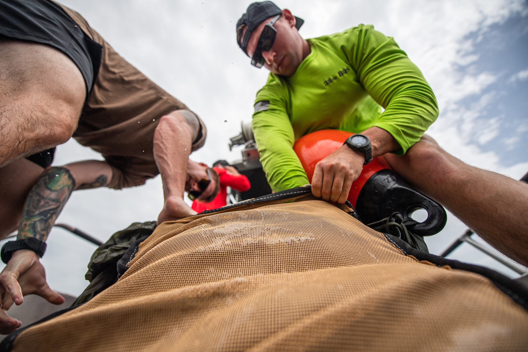 Photo of Airmen packing a bag with a parachute
