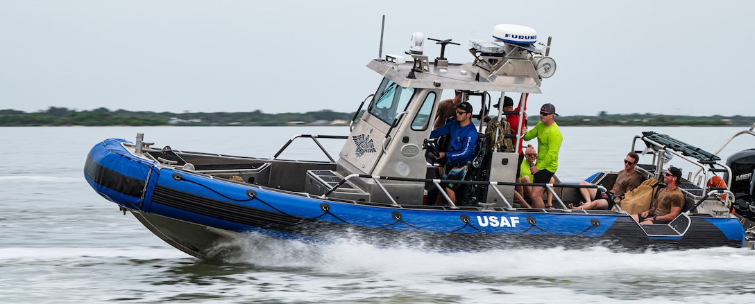 Photo of Airmen driving a boat