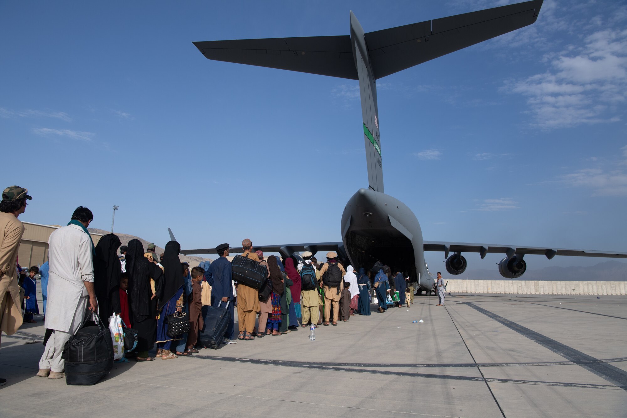 U.S. Air Force loadmasters and pilots assigned to the 816th Expeditionary Airlift Squadron, load passengers aboard a U.S. Air Force C-17 Globemaster III in support of the Afghanistan evacuation at Hamid Karzai International Airport (HKIA), Afghanistan, Aug. 24, 2021.