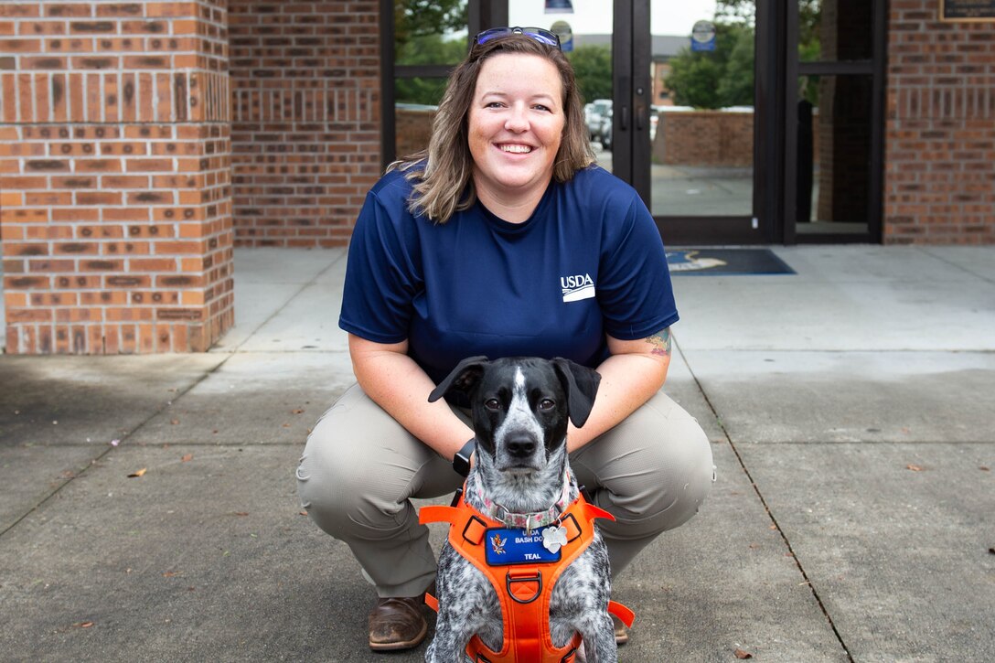 A photo of a biologist and her dog.