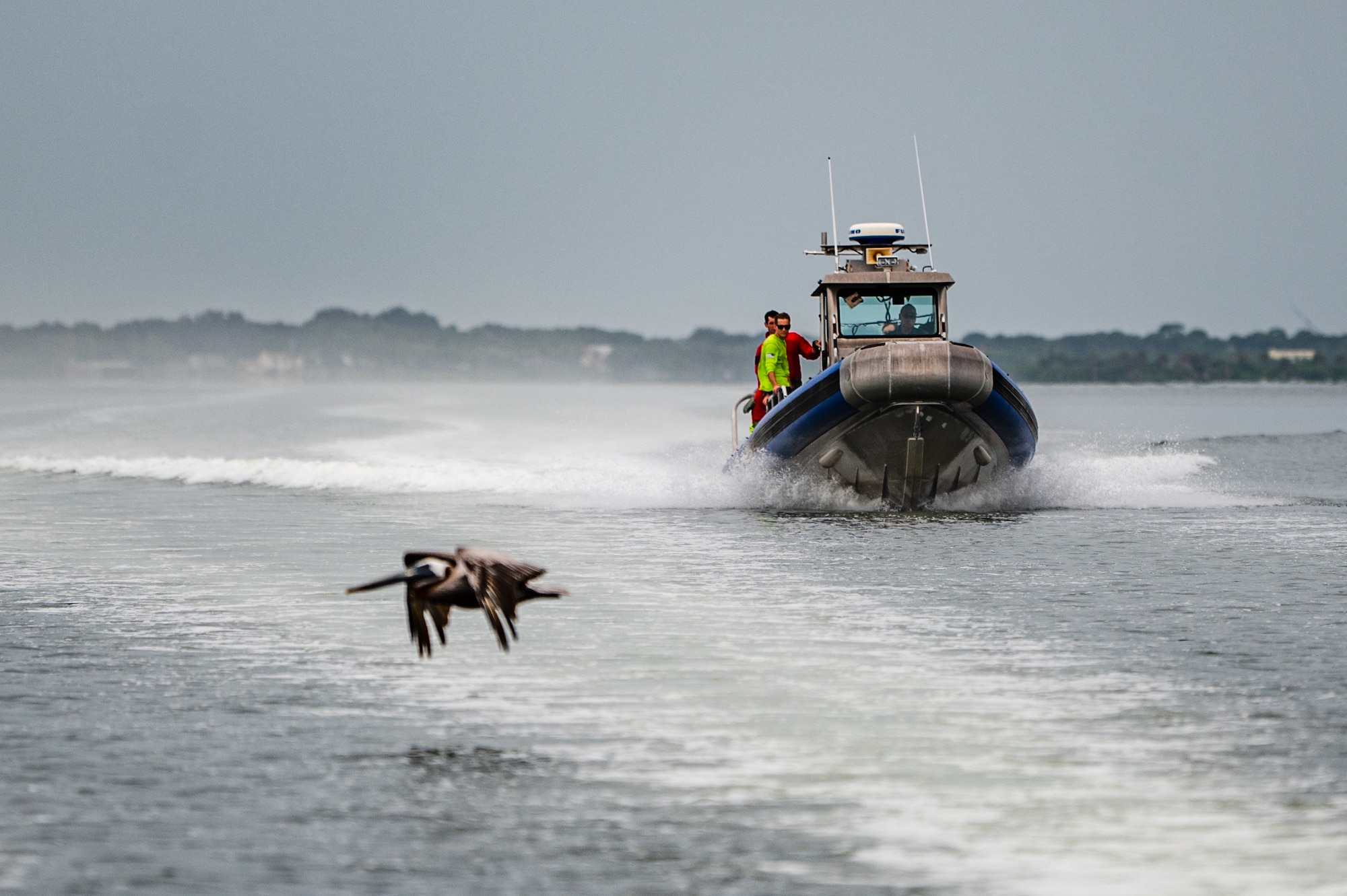 Photo of Airman parachuting into the water