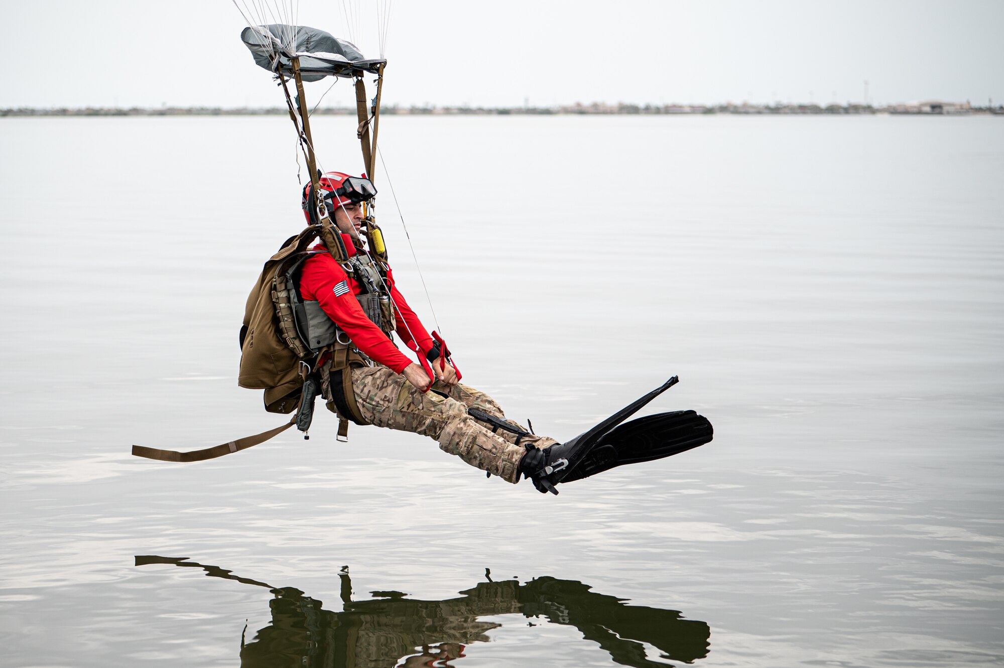 Photo of Airman parachuting into the water