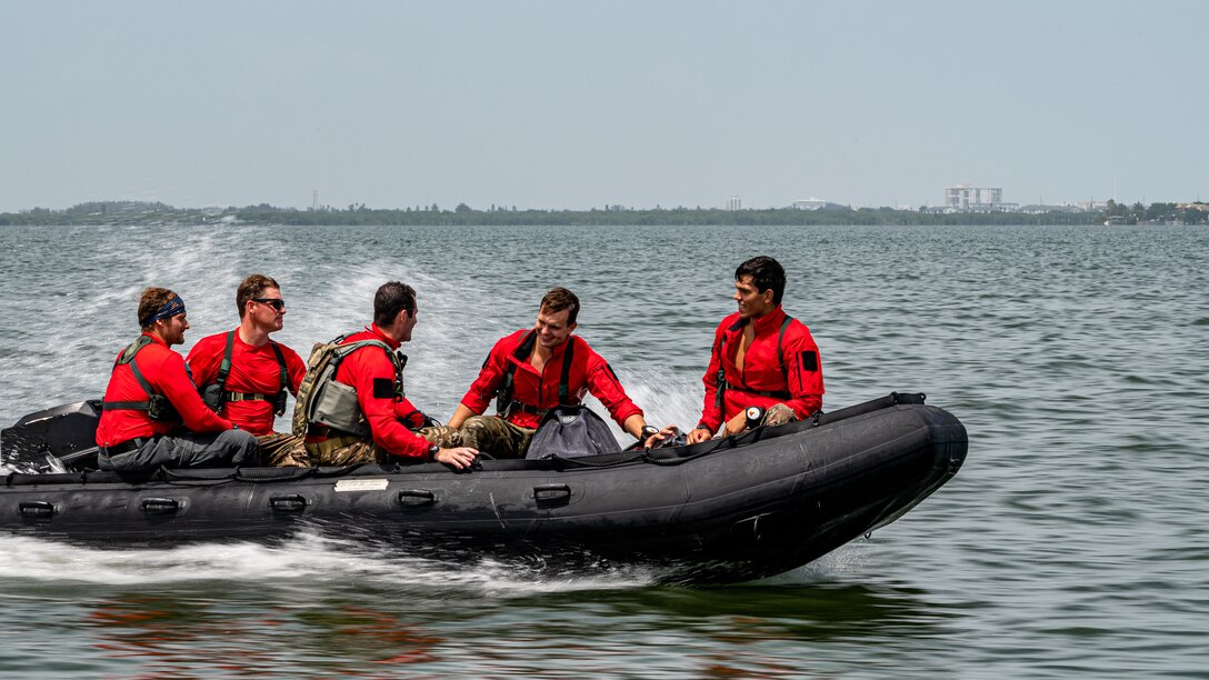 Photo of Airmen driving a boat