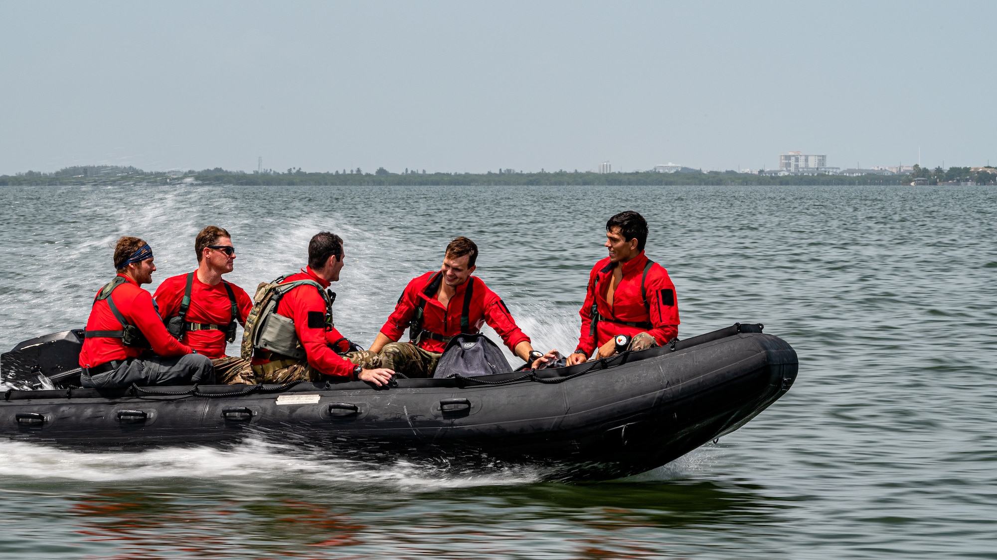 Photo of Airmen driving a boat