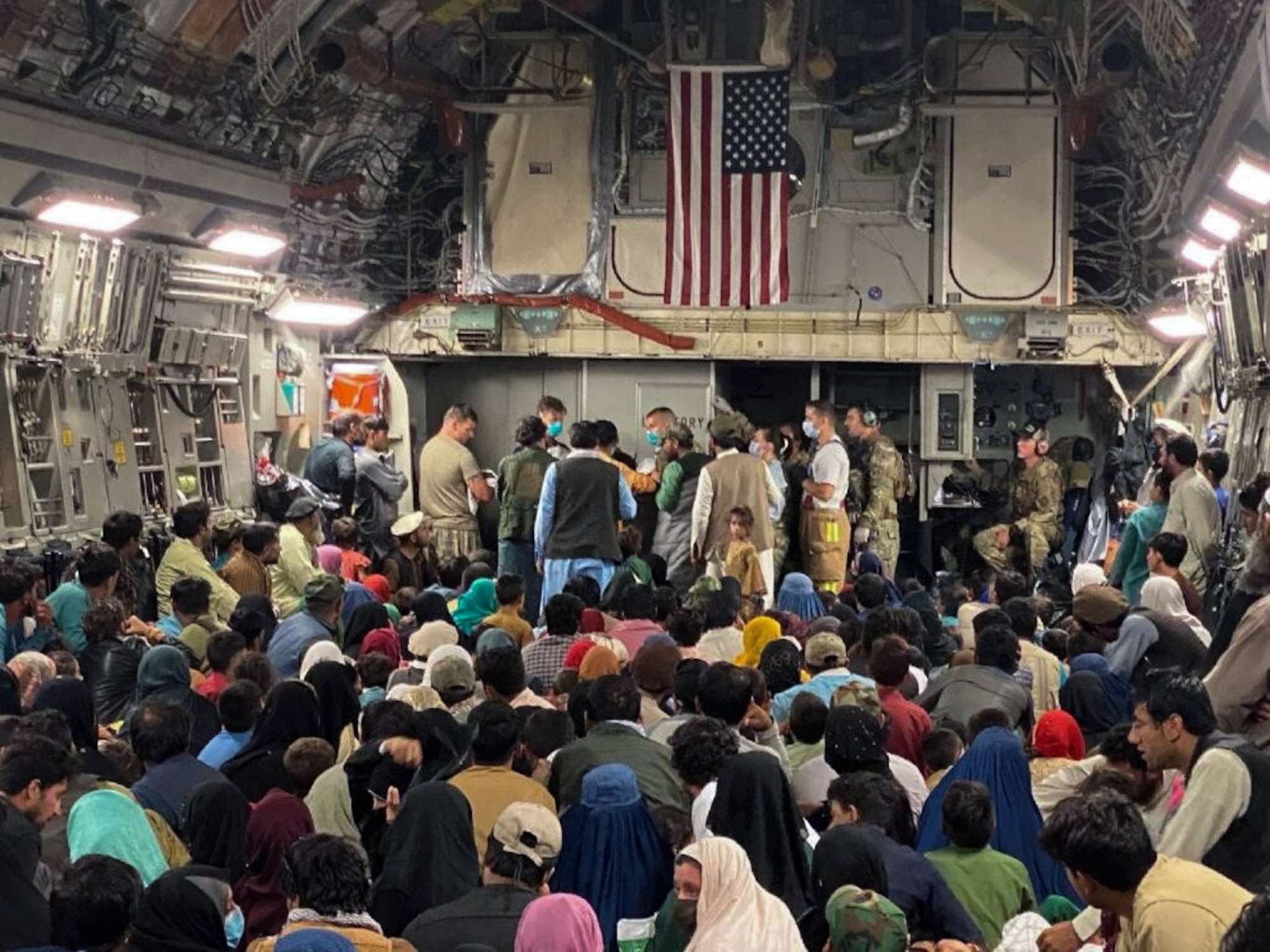 A newborn baby is cared for prior to departing a C-17 Globemaster III, August 23, 2021 at a Middle East staging area. A 315th Airlift Wing aircrew from Joint Base Charleston, S.C. helped deliver the baby while aboard a C-17 Globemaster III carrying Afghans evacuated from Afghanistan moments before landing at a Middle East staging area.