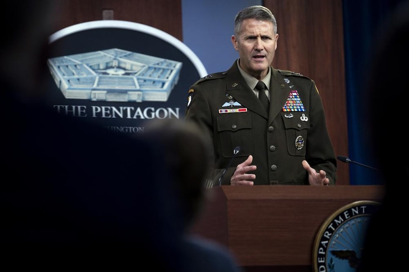 An Army officer speaks at a podium.