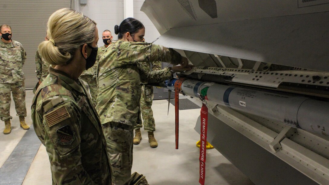 Maj. Gen. Michele C. Edmondson, 2nd Air Force commander, observes Tech. Sgt. Alexandria Anguiano secure a training munition