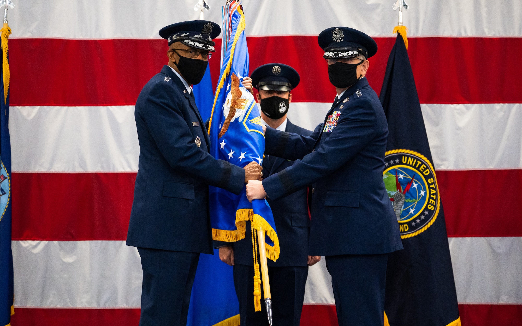 Gen. Tim Ray, right, outgoing Air Force Global Strike Command commander, relinquishes the guidon to Air Force Chief of Staff Gen. CQ Brown, Jr., left, during the AFGSC change of command ceremony at Barksdale Air Force Base, Louisiana, Aug. 27, 2021. The passing of a unit’s guidon symbolizes a transfer of command. (U.S. Air Force photo by Senior Airman Jacob B. Wrightsman)